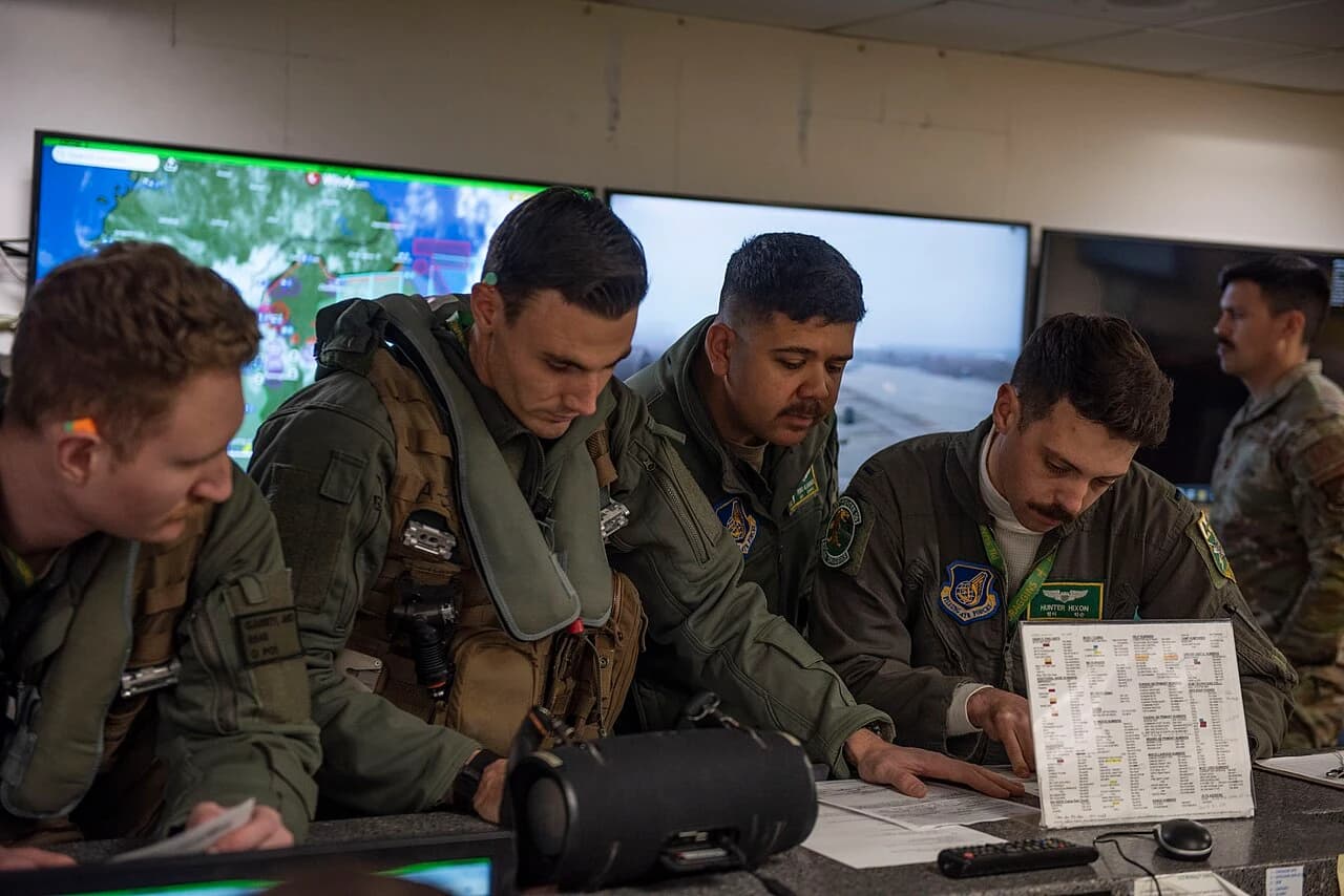 Flight crew reviewing planning documents and weather information before departure