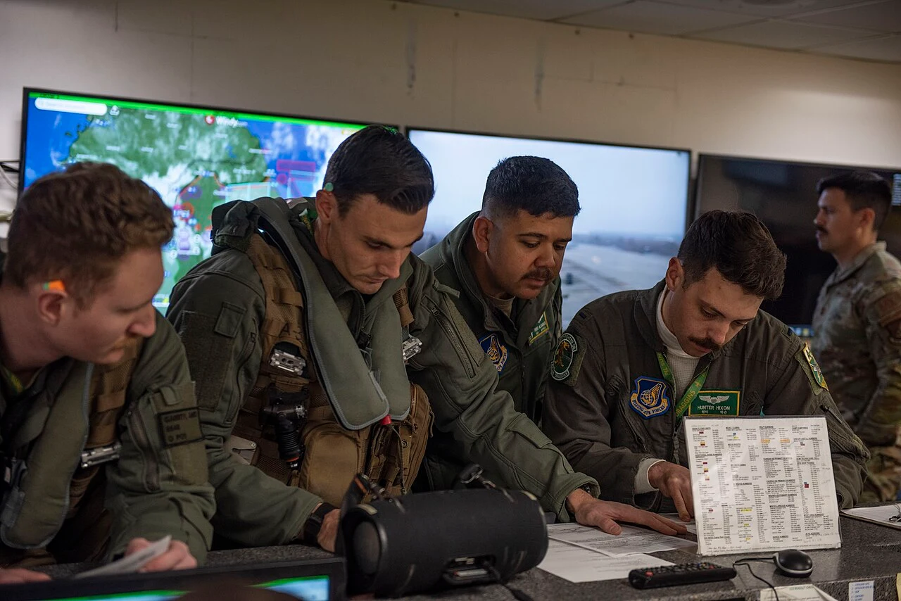 Flight crew reviewing planning documents and weather information before departure
