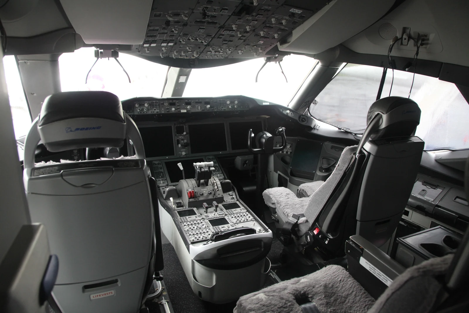 Boeing 787 flight deck with pilot seats, controls and instrument panels